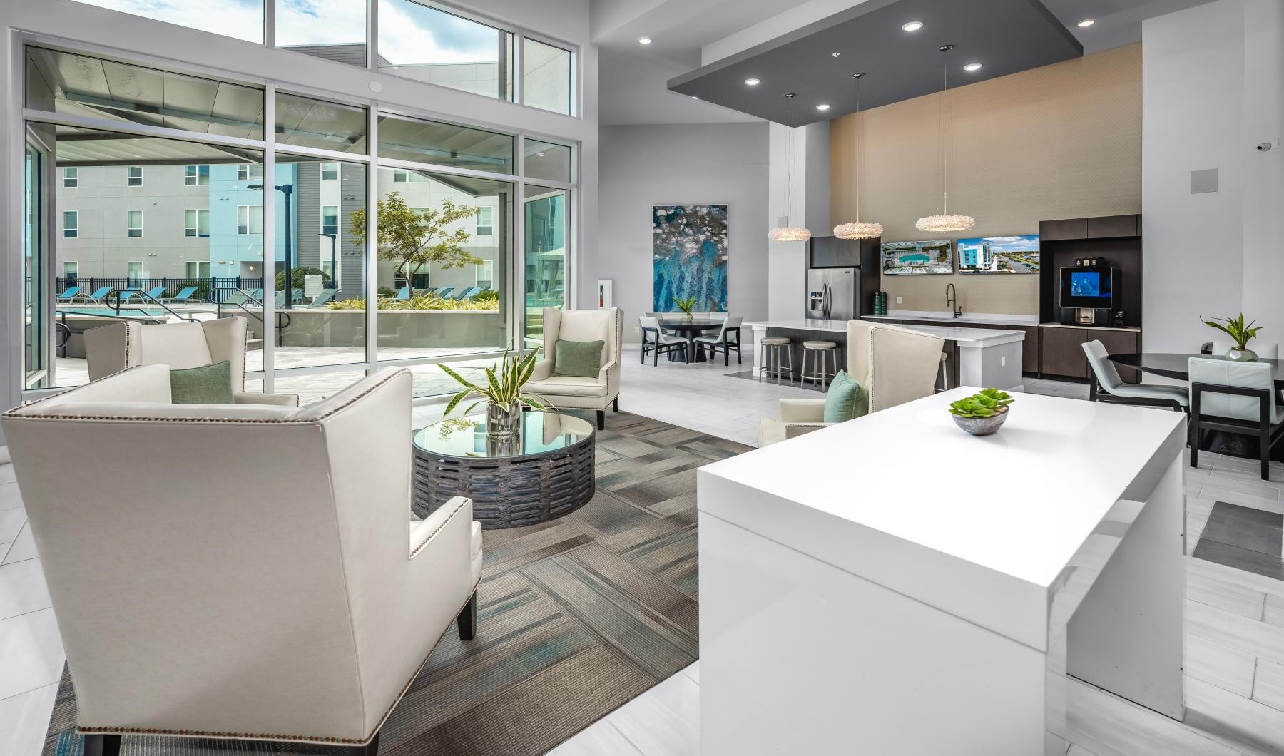 a room with a large white table and chairs