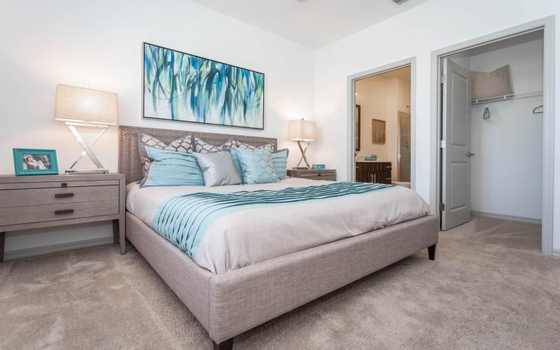 a bedroom with a bed and lamps